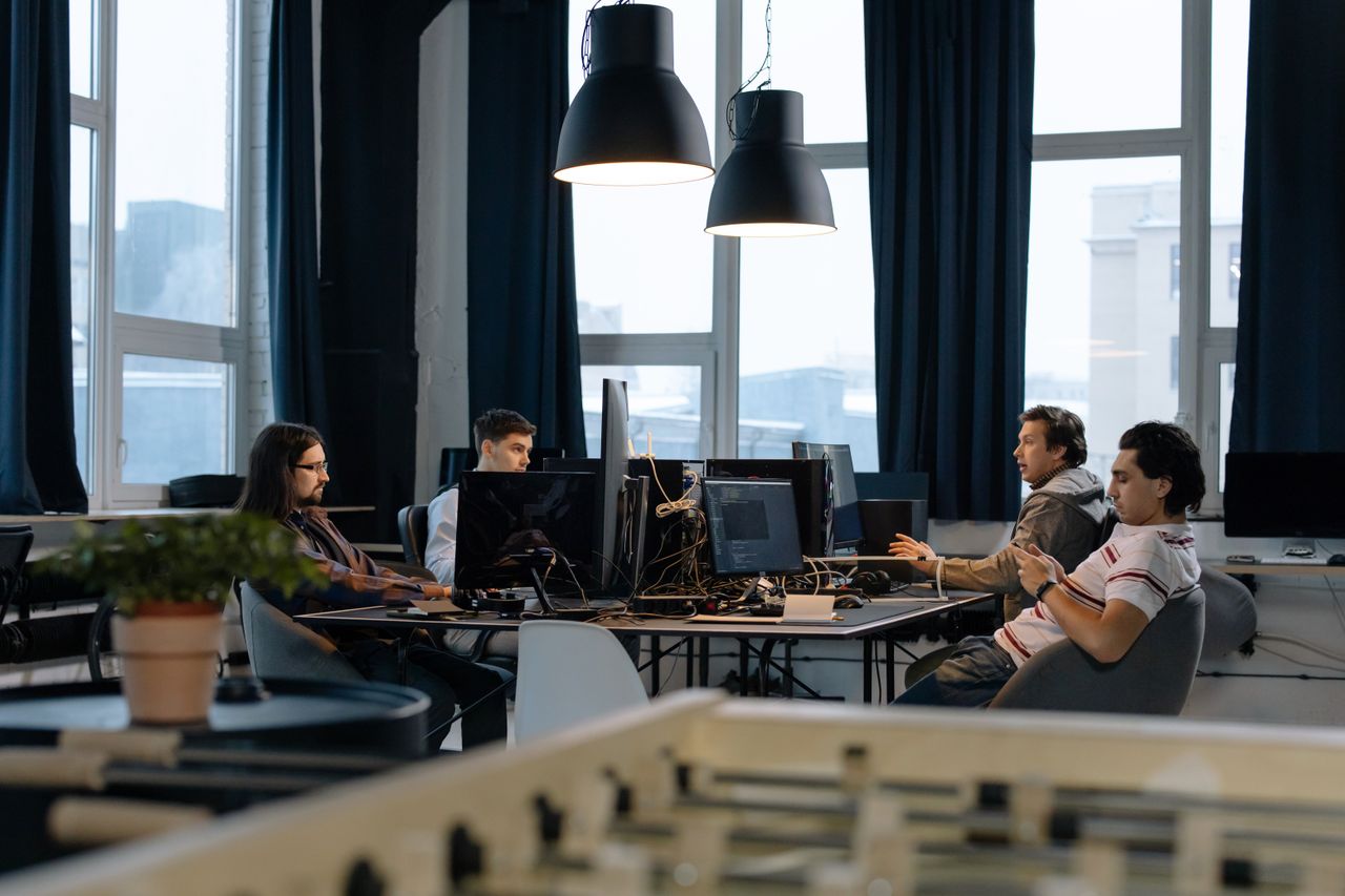 Mastering the First Impression: Your intriguing post title goes here Workers collaborate in a modern office with computers, showcasing teamwork in technology development.